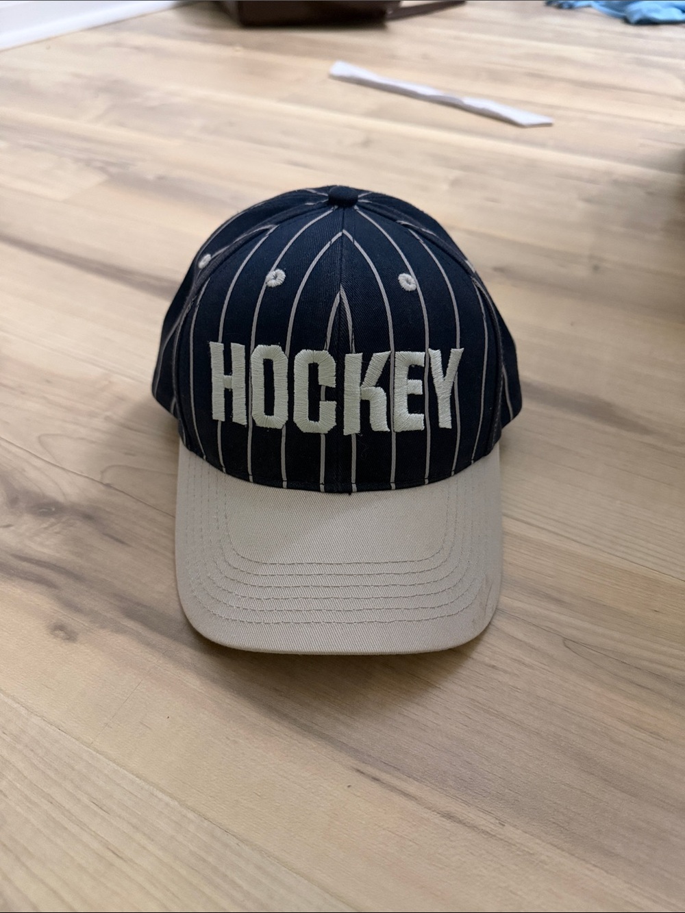 Hockey eyes without a face white and navy striped hat